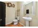 Clean bathroom with pedestal sink and wood flooring at 5105 Deepwater Cv, Acworth, GA 30101