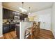 Kitchen with dark cabinets and breakfast bar at 5105 Deepwater Cv, Acworth, GA 30101