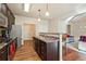 Modern kitchen with dark brown cabinets and stainless steel appliances at 5105 Deepwater Cv, Acworth, GA 30101