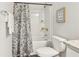 Well-appointed bathroom with floral shower curtain and bathtub at 633 Cygnet Ln, Grayson, GA 30017