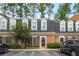 Brick front of charming townhome with mature landscaping and parking at 12 Independence Nw Pl # 12, Atlanta, GA 30318