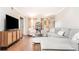 Spacious living room with hardwood floors, sectional sofa, and large TV at 12 Independence Nw Pl # 12, Atlanta, GA 30318