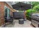 Relaxing patio with seating, umbrella, fire pit, and grill at 12 Independence Nw Pl # 12, Atlanta, GA 30318