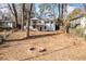 Large backyard with firepit, surrounded by trees and a white house at 1985 Seaboard Nw, Atlanta, GA 30318