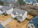 Aerial view of two-story house with front yard and driveway at 1690 Geranium Ln, Cumming, GA 30040