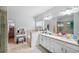 Elegant bathroom featuring a double vanity and a large soaking tub at 1690 Geranium Ln, Cumming, GA 30040