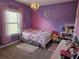 Charming bedroom with purple and pink walls and a comfortable bed at 1690 Geranium Ln, Cumming, GA 30040