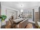 Elegant dining room with a large table, bench seating and chandelier at 1690 Geranium Ln, Cumming, GA 30040