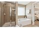 Bathroom with a shower, garden tub, and window at 3648 Ramsey Close Sw, Atlanta, GA 30331