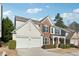 Two-story house with a two car garage and landscaping at 3648 Ramsey Close Sw, Atlanta, GA 30331