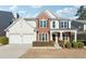 Two-story home with brick and siding, a two-car garage and landscaping at 3648 Ramsey Close Sw, Atlanta, GA 30331