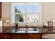 Kitchen features dark wood cabinets, granite countertops and a double sink at 3648 Ramsey Close Sw, Atlanta, GA 30331