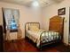 Bedroom with hardwood floors and vintage headboard at 4350 Rockdale Dr, Acworth, GA 30101