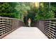 Personal riding a bike across a wooden bridge at 4350 Rockdale Dr, Acworth, GA 30101