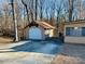 Detached garage with large door in wooded setting at 4350 Rockdale Dr, Acworth, GA 30101