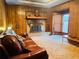 Living room with brick fireplace, wood paneling, and bay window at 4350 Rockdale Dr, Acworth, GA 30101