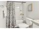 Full bathroom with floral shower curtain and granite countertop at 563 Cygnet Ln, Grayson, GA 30017