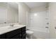 Bathroom with dark vanity, white tub/shower, and toilet at 8775 Village Pl, Suwanee, GA 30024