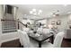 Elegant dining room with dark wood table and white chairs at 8775 Village Pl, Suwanee, GA 30024