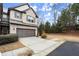 Two-story home with attached garage and snowy scene at 8775 Village Pl, Suwanee, GA 30024