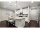 Modern kitchen with white cabinets, granite island and hardwood floors at 8775 Village Pl, Suwanee, GA 30024