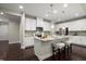 Modern kitchen with white cabinets, granite island and hardwood floors at 8775 Village Pl, Suwanee, GA 30024