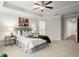 Large main bedroom with plush carpet, ceiling fan, and en-suite bathroom at 8775 Village Pl, Suwanee, GA 30024