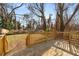 Deck view of fenced backyard and mature trees at 942 Lawton Sw St, Atlanta, GA 30310