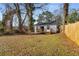 House and backyard with mature trees and a deck at 942 Lawton Sw St, Atlanta, GA 30310