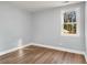 Light grey walls and wood-look floors in this spacious bedroom at 942 Lawton Sw St, Atlanta, GA 30310