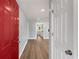 Bright entryway with red door and view into living area at 942 Lawton Sw St, Atlanta, GA 30310