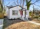 Newly renovated white house with red door, steps and walkway at 942 Lawton Sw St, Atlanta, GA 30310