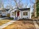 Newly renovated white house with red door, steps and walkway at 942 Lawton Sw St, Atlanta, GA 30310