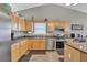 Modern kitchen with stainless steel appliances and light wood cabinets at 2751 Maeve Ct, Dacula, GA 30019