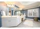 Elegant bathroom with double vanity, large mirror, and stylish light fixtures at 2057 Chambord Way, Snellville, GA 30078