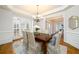 Elegant dining room with hardwood floors, crown molding, and a chandelier at 2057 Chambord Way, Snellville, GA 30078