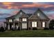 Brick house exterior at dusk, showcasing architectural details at 2057 Chambord Way, Snellville, GA 30078