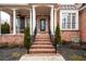 Brick front porch with columns and steps leading to the entrance at 2057 Chambord Way, Snellville, GA 30078