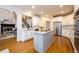 Modern kitchen with white cabinets, a large island, and stainless steel appliances at 2057 Chambord Way, Snellville, GA 30078