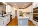 Modern kitchen with white cabinets, a large island, and stainless steel appliances at 2057 Chambord Way, Snellville, GA 30078