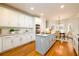 Modern kitchen with white cabinets, a large island, and stainless steel appliances at 2057 Chambord Way, Snellville, GA 30078