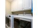 Convenient laundry room with Maytag washer and dryer, and upper cabinets at 2057 Chambord Way, Snellville, GA 30078