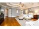 Bright main bedroom featuring hardwood floors and access to the ensuite bathroom at 2057 Chambord Way, Snellville, GA 30078