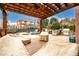 Relaxing pergola covered patio with seating area overlooking pool at 2057 Chambord Way, Snellville, GA 30078