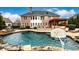 Stunning in-ground pool with brick patio and basketball goal at 2057 Chambord Way, Snellville, GA 30078