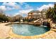 Resort-style pool with slide, waterfall and spacious patio at 2057 Chambord Way, Snellville, GA 30078