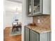 Butlers pantry with granite countertop and glass-front cabinets at 2590 Knox Ne St, Atlanta, GA 30317