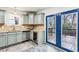 Kitchen corner with granite countertop, wine fridge, and blue doors to deck at 2590 Knox Ne St, Atlanta, GA 30317