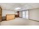 Spacious finished basement with carpeting, wood paneling, and sliding glass doors at 9385 N Lake Dr, Roswell, GA 30076