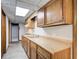 Long view of a galley-style basement kitchen with wood cabinets at 9385 N Lake Dr, Roswell, GA 30076